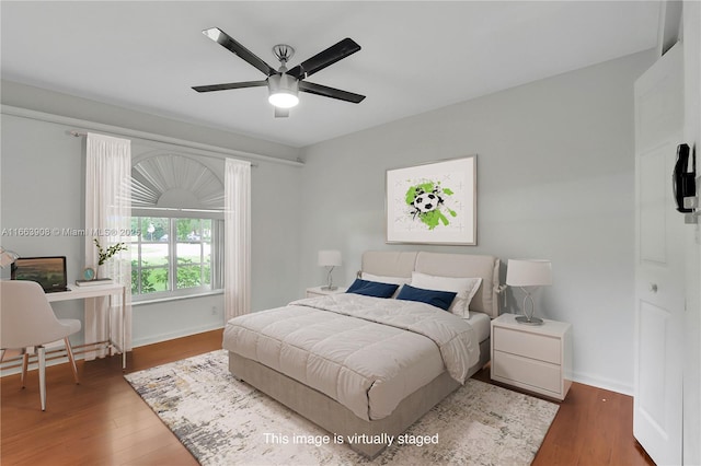 bedroom with ceiling fan and dark hardwood / wood-style floors