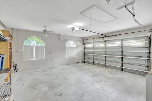 garage featuring ceiling fan and a garage door opener