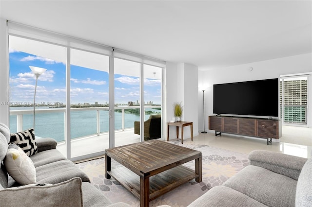 living room with a water view and a wall of windows