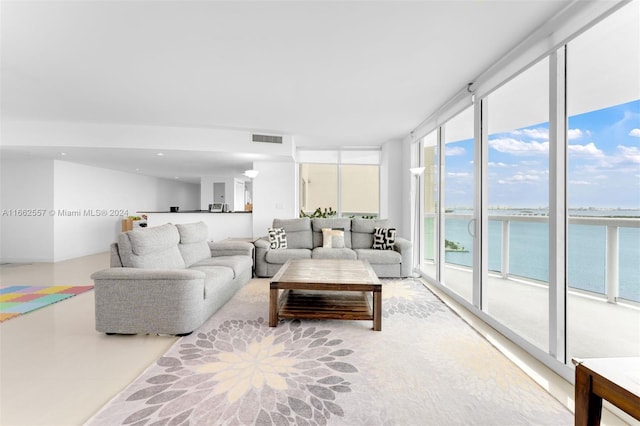 living room with a wall of windows and a water view