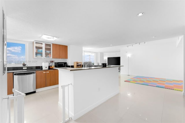 kitchen featuring dishwasher, a center island, and light tile patterned flooring