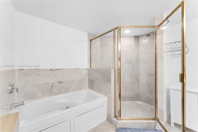 bathroom with separate shower and tub