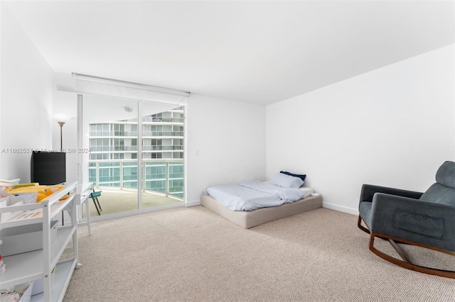 carpeted bedroom featuring access to outside