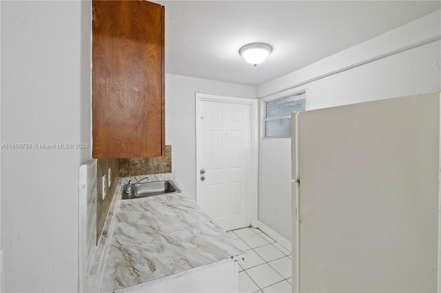 interior space with light tile patterned floors and sink