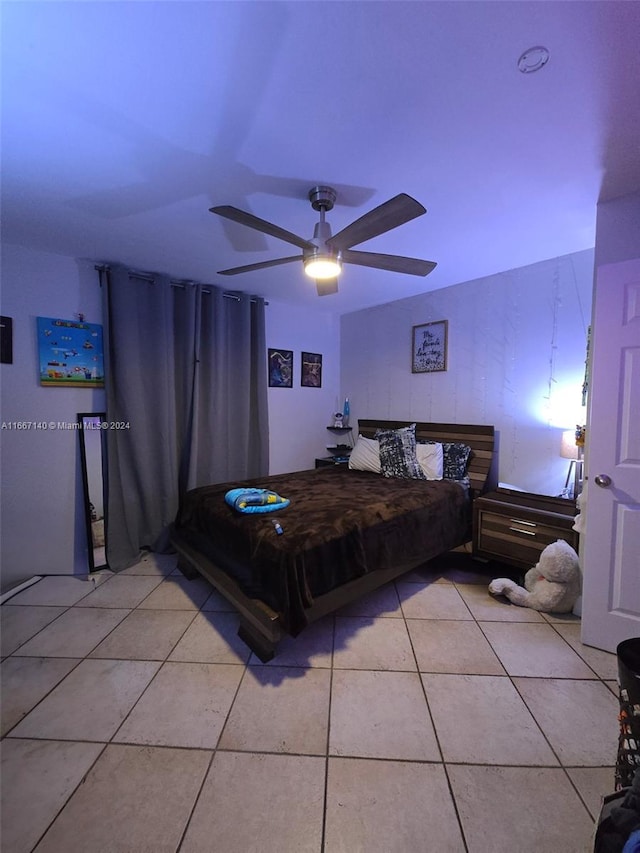 bedroom featuring light tile patterned flooring and ceiling fan