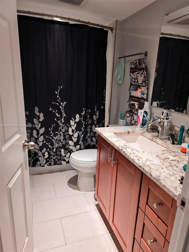 bathroom featuring tile patterned flooring, vanity, and toilet