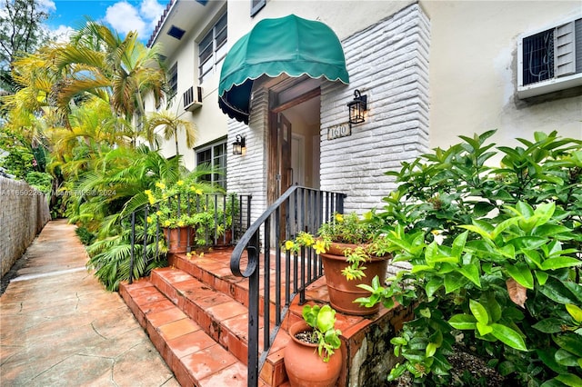 entrance to property featuring cooling unit