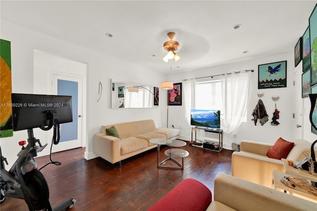 living room featuring dark hardwood / wood-style floors and ceiling fan