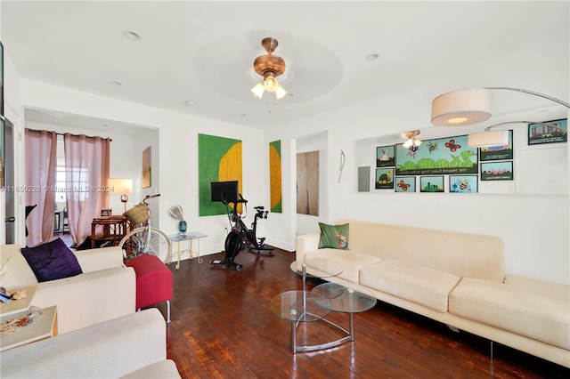 living room with ceiling fan and dark wood-type flooring