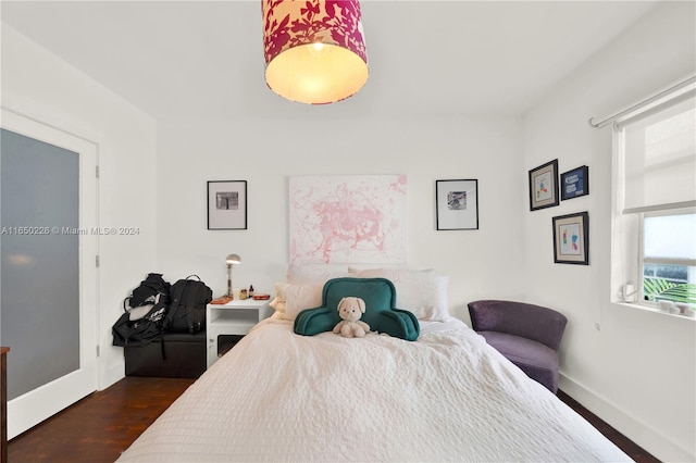 bedroom with dark hardwood / wood-style flooring