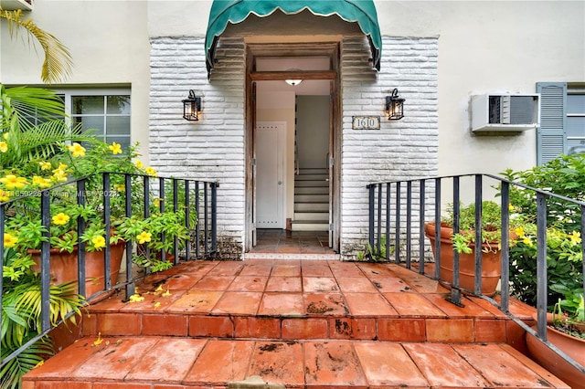 property entrance featuring a wall unit AC