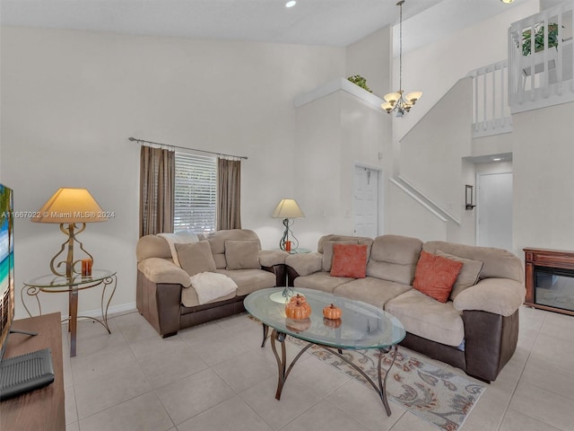 tiled living room with an inviting chandelier and high vaulted ceiling