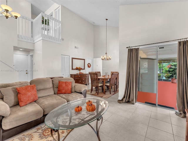 tiled living room featuring an inviting chandelier and high vaulted ceiling