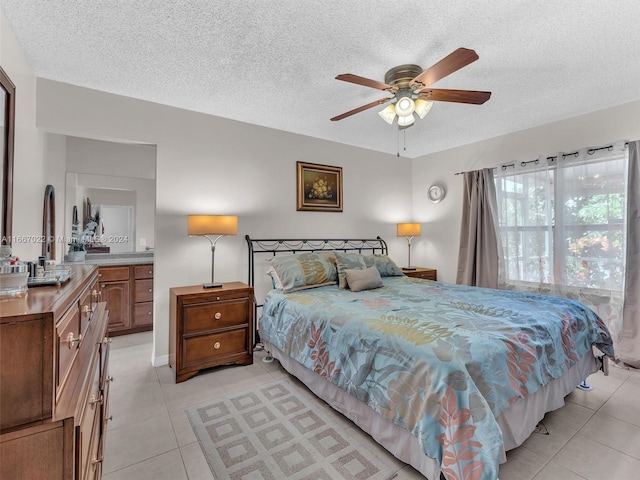 tiled bedroom featuring a textured ceiling and ceiling fan