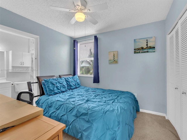 carpeted bedroom featuring a closet, ceiling fan, and a textured ceiling