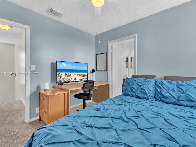 carpeted bedroom with a textured ceiling and ceiling fan