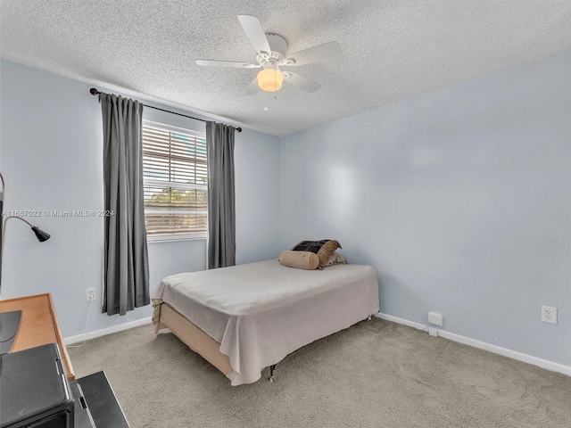 carpeted bedroom with a textured ceiling and ceiling fan