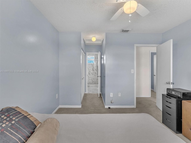 bedroom with ceiling fan, a textured ceiling, and light carpet