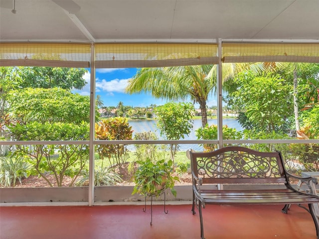 unfurnished sunroom featuring a water view and plenty of natural light