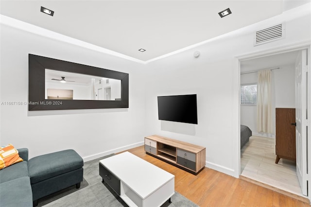 living room featuring ceiling fan and hardwood / wood-style floors