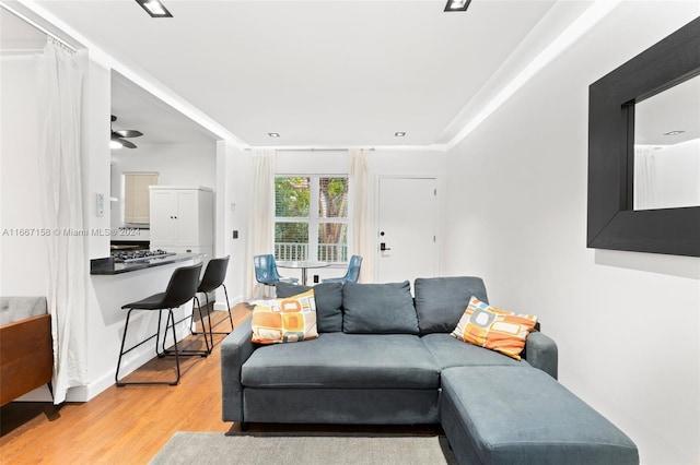 living room featuring ceiling fan and light hardwood / wood-style floors