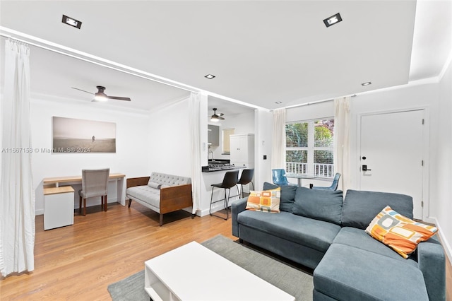 living room with ceiling fan and light hardwood / wood-style floors