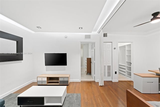 unfurnished living room with ceiling fan and light wood-type flooring