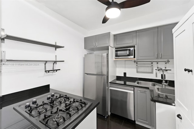 kitchen with gray cabinetry, ceiling fan, sink, and appliances with stainless steel finishes