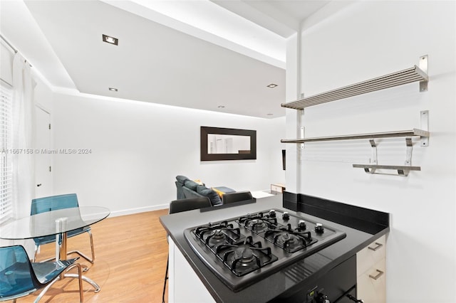 kitchen featuring white cabinets, gas stovetop, and hardwood / wood-style floors