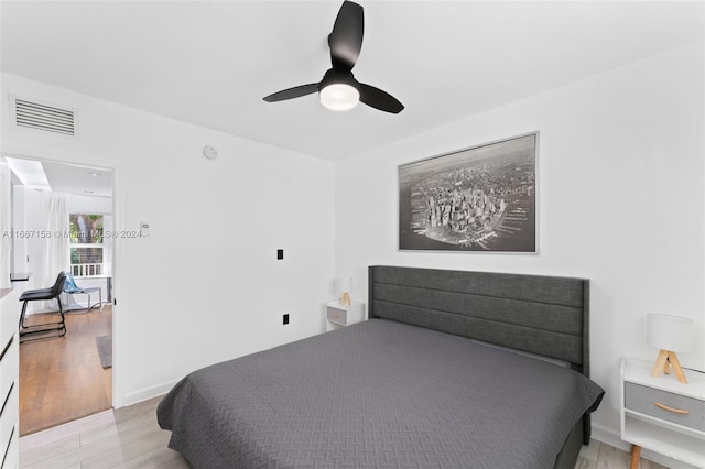 bedroom with ceiling fan and light hardwood / wood-style floors