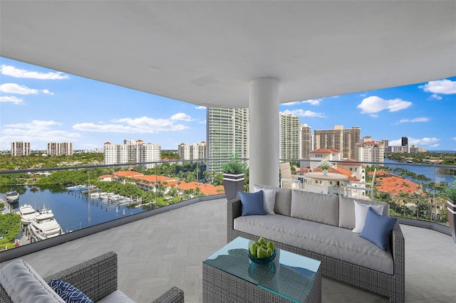 balcony featuring a water view and an outdoor living space