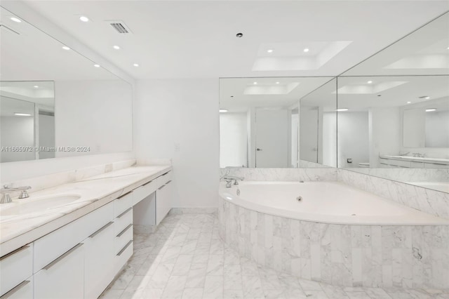 bathroom featuring vanity and a relaxing tiled tub