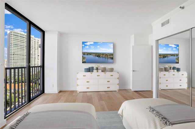 bedroom featuring light wood-type flooring and multiple windows