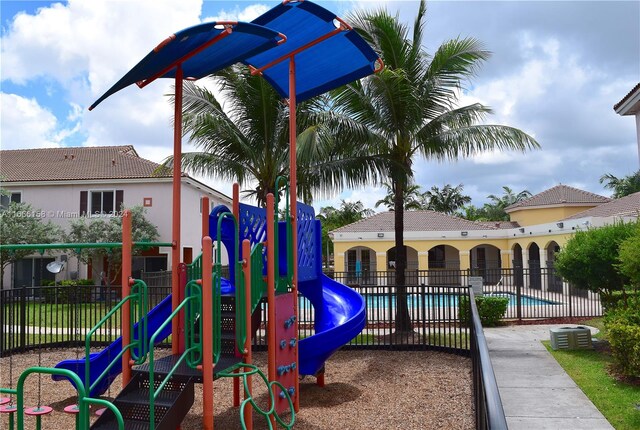 view of jungle gym with a community pool