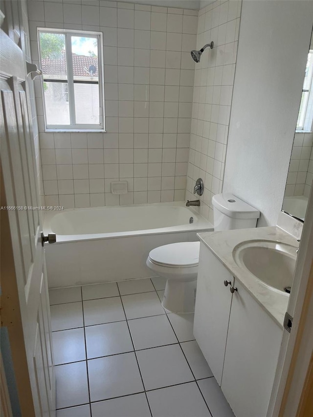 full bathroom featuring vanity, tiled shower / bath combo, toilet, and tile patterned floors