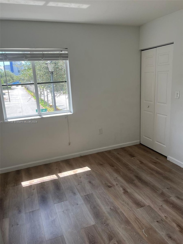 unfurnished bedroom featuring dark hardwood / wood-style floors