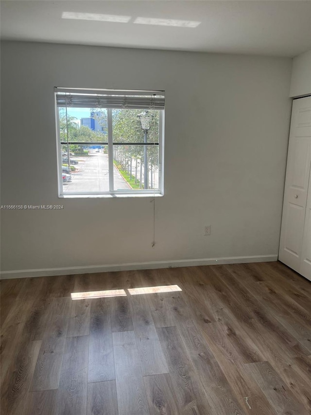 spare room featuring dark hardwood / wood-style flooring