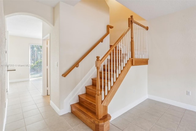 stairs featuring tile patterned flooring