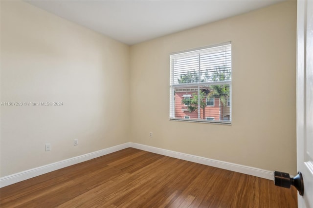 empty room with wood-type flooring