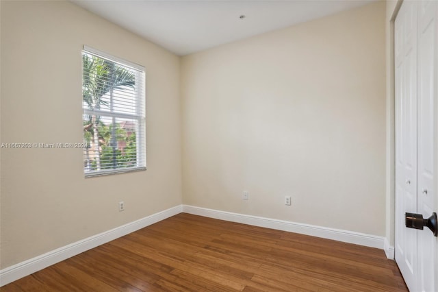 unfurnished bedroom with wood-type flooring and a closet