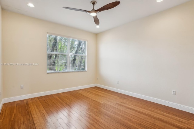 spare room featuring hardwood / wood-style floors and ceiling fan