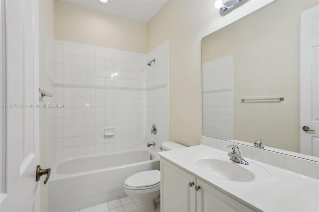 full bathroom featuring tile patterned flooring, tiled shower / bath combo, vanity, and toilet