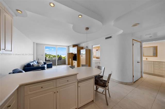 kitchen featuring decorative light fixtures and light tile patterned floors