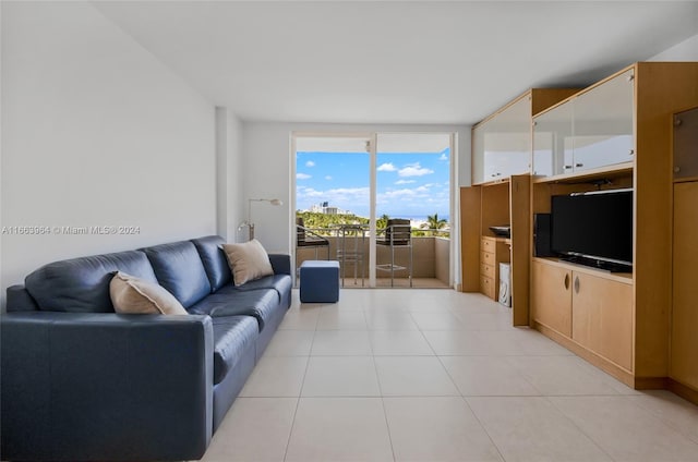 tiled living room featuring floor to ceiling windows