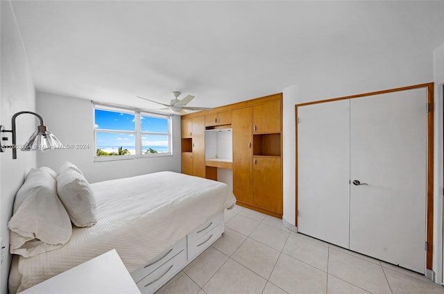 bedroom featuring a closet, ceiling fan, and light tile patterned floors