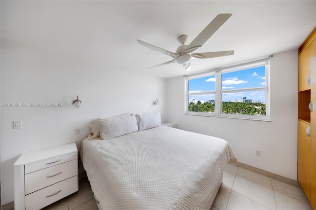 tiled bedroom featuring ceiling fan