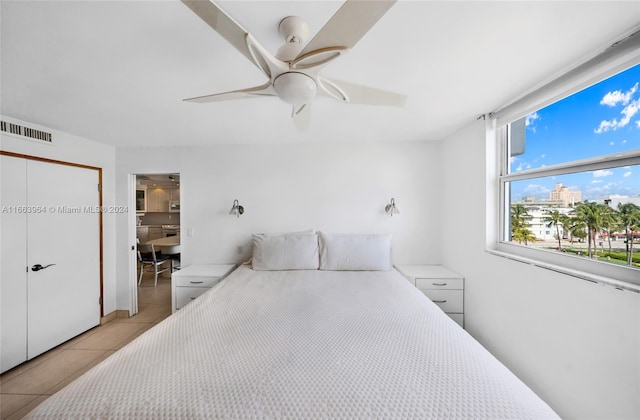 bedroom with ceiling fan and light tile patterned floors