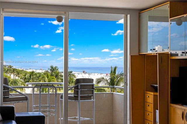 interior space with a beach view and a water view