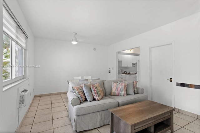 living room with ceiling fan and light tile patterned floors