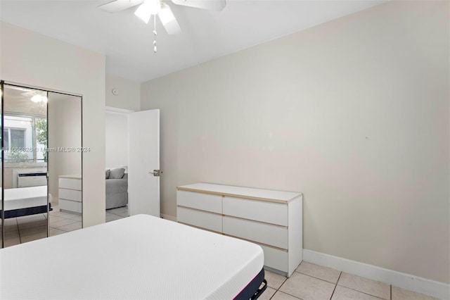 tiled bedroom featuring ceiling fan